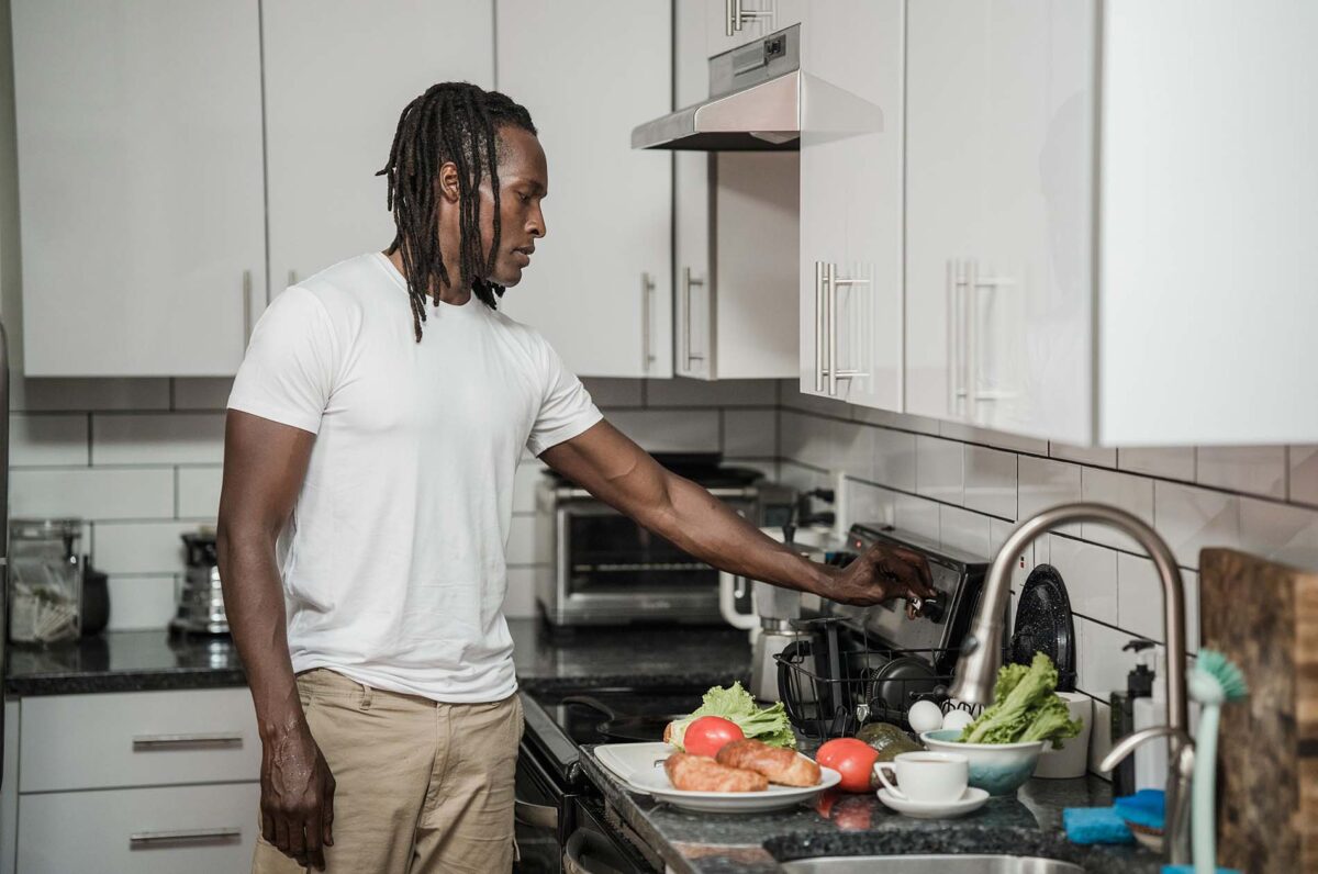 Photo of a man cooking a nutritional weight loss meal.